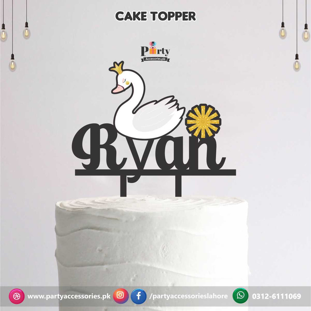 Swan theme cake topper on wooden sheet